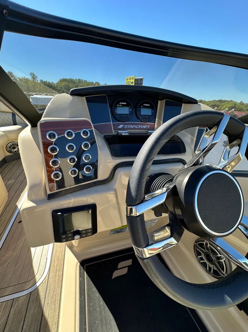 Slide: The Image of 2024 Starcraft RX23QDC 3.0 boat dashboard with steering wheel and control panel. - 9