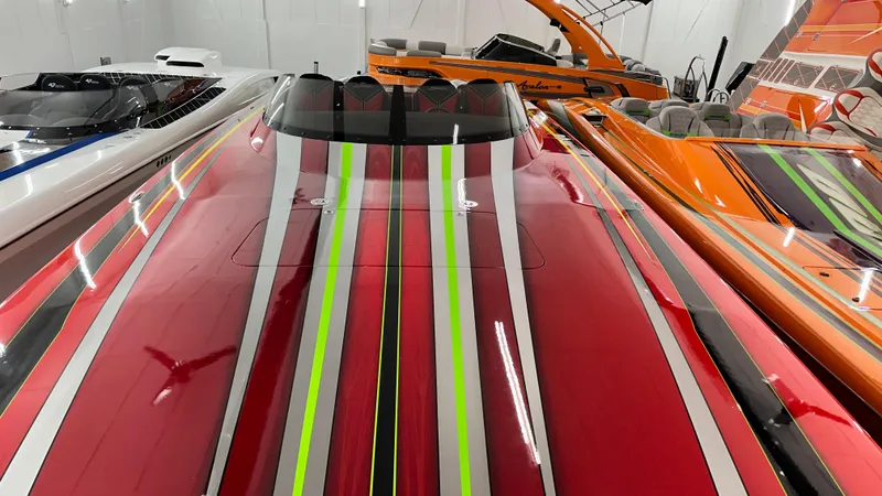 Slide: The Image of Colorful Skater 438 speedboats in a showroom, featuring vibrant stripes, 2021 model. - 14