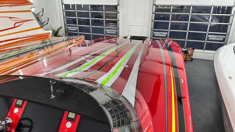 Slide: The Image of Red Skater 438 boat with colorful stripes in a showroom, 2021 model. - 16