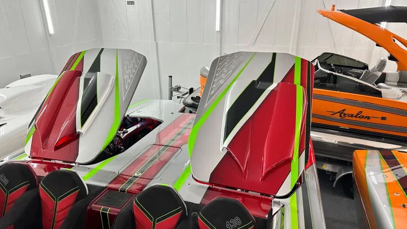 Slide: The Image of Colorful Skater 438 speedboat with vibrant red, green, and white design in a showroom. - 5