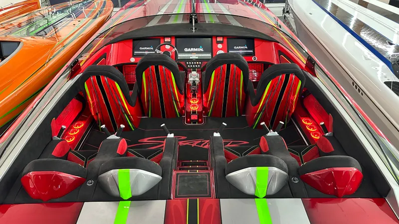 Slide: The Image of Vibrant interior of 2021 Skater 438 speedboat with red and green accents, featuring advanced Garmin navigation. - 7