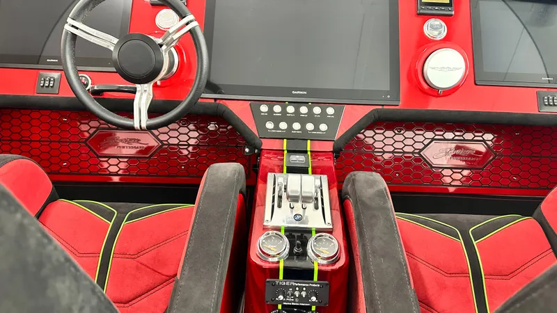 Slide: The Image of Red and black Skater 438 boat interior with modern controls and steering wheel, 2021 model. - 9