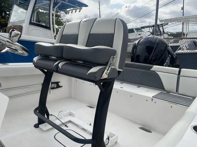Slide: The Image of 2020 Tidewater 232 LXF boat interior with dual seats and steering console. - 10