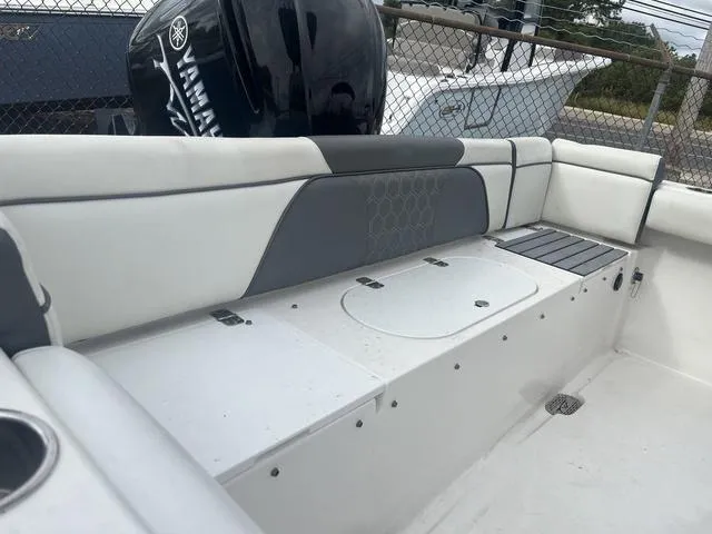 Slide: The Image of 2020 Tidewater 232 LXF boat interior with cushioned seating and storage compartments. - 4