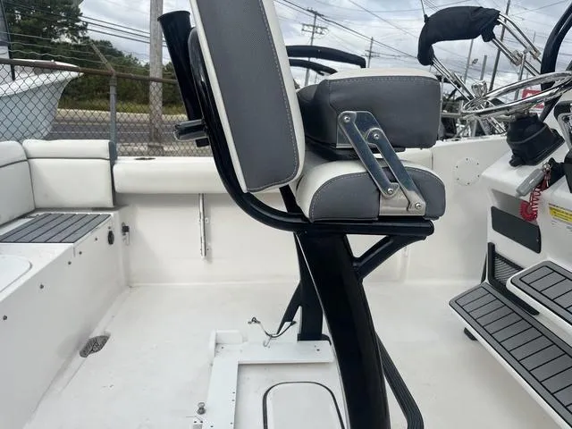 Slide: The Image of 2020 Tidewater 232 LXF boat interior with seating and steering console. - 5