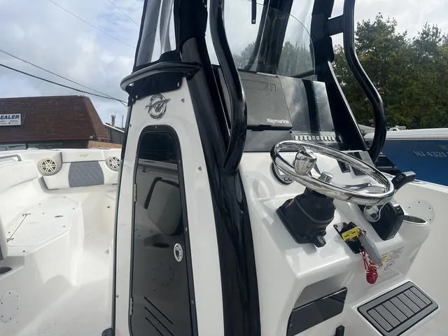 Slide: The Image of 2020 Tidewater 232 LXF boat console with steering wheel and navigation equipment. - 7