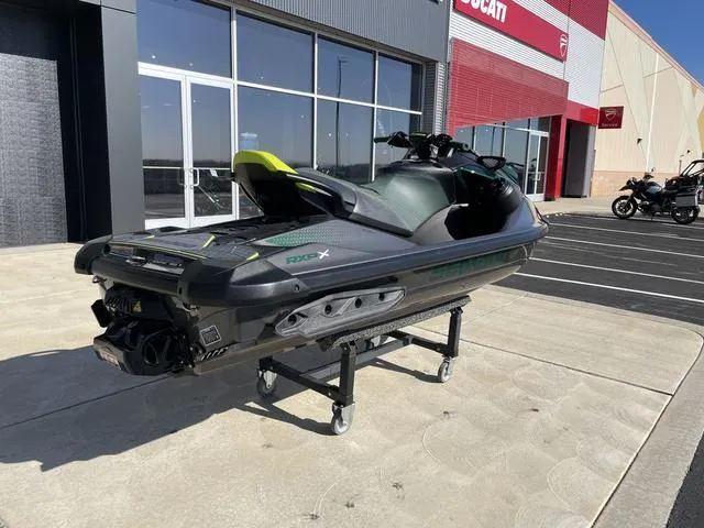 Slide: The Image of 2023 Sea-Doo Waverunner RXP-X Apex 300 displayed outdoors on a stand. - 8