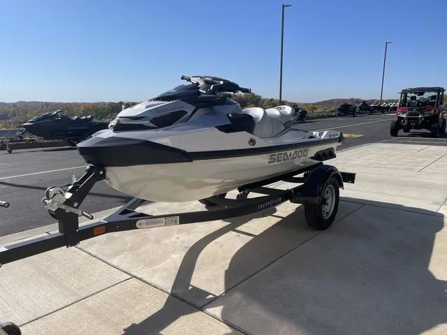 Slide: The Image of 2024 Sea-Doo Waverunner GTX on trailer, parked outdoors under clear blue sky. - 4
