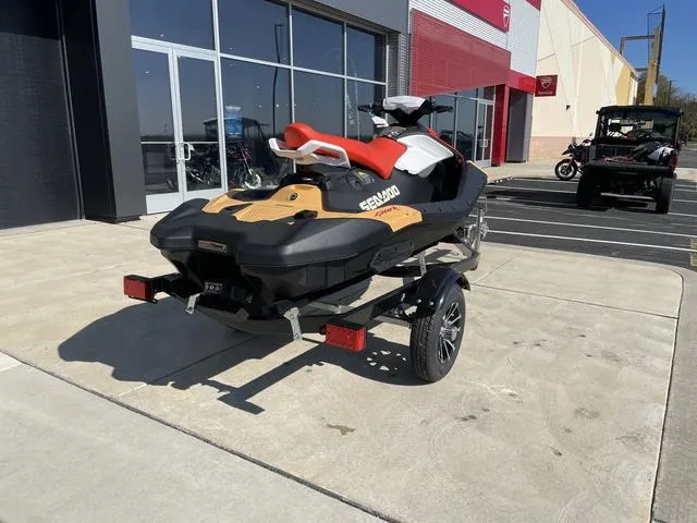 Slide: The Image of 2024 Sea-Doo Waverunner Spark on trailer, parked outside a building. - 3