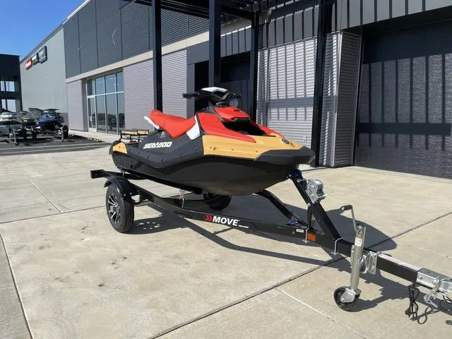 Slide: The Image of 2024 Sea-Doo Waverunner Spark on trailer, parked outside a modern building. - 4