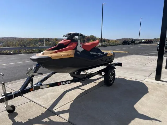Slide: The Image of 2024 Sea-Doo Waverunner Spark on trailer, parked outdoors under clear blue sky. - 6