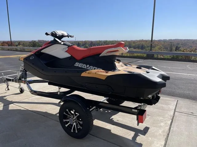 Slide: The Image of 2024 Sea-Doo Waverunner Spark on trailer, parked outdoors under clear sky. - 8