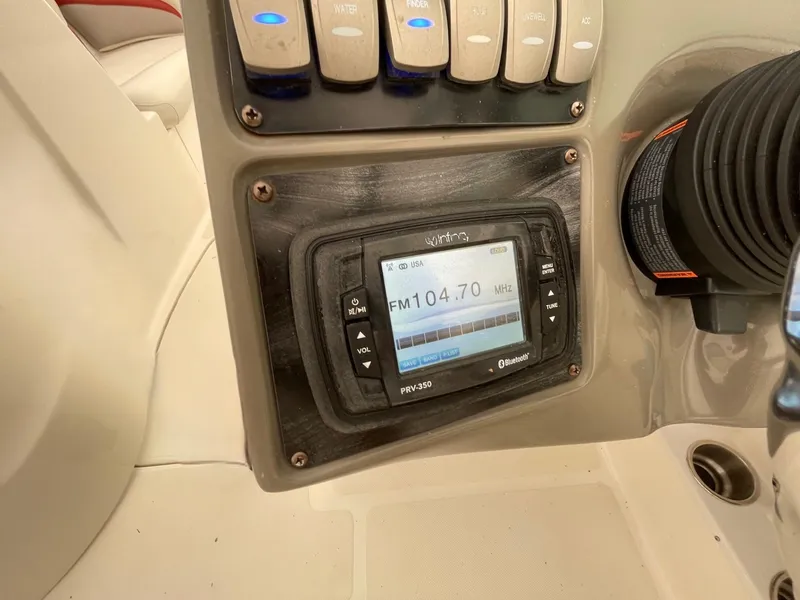 Slide: The Image of 2016 Hurricane SD2200 O/B boat dashboard with radio display and controls. - 14