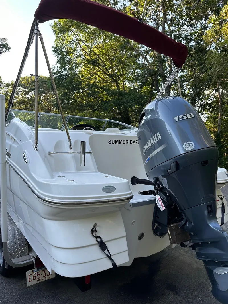 Slide: The Image of 2016 Hurricane SD2200 O/B boat with Yamaha 150 engine, parked outdoors. - 2