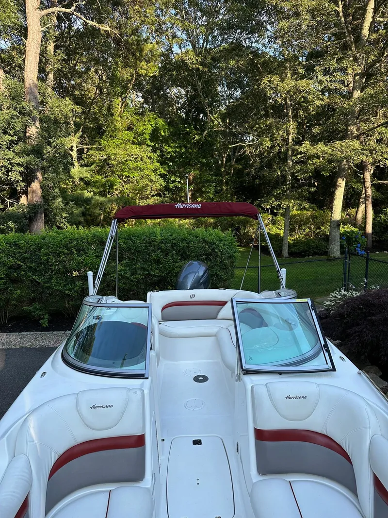 Slide: The Image of 2016 Hurricane SD2200 O/B boat with red canopy in lush green setting. - 5