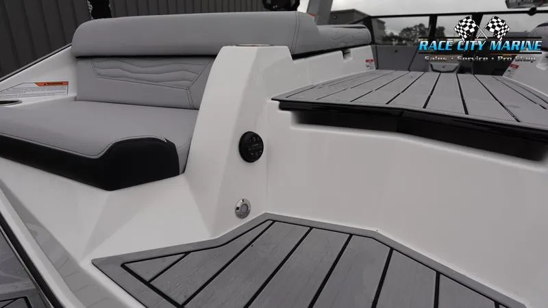Slide: The Image of 2025 Nautique Super Air Nautique G23 boat interior with sleek seating and deck design. - 14