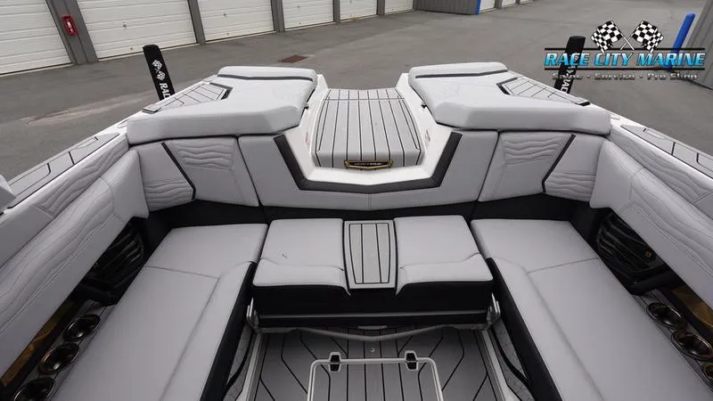 Slide: The Image of 2025 Nautique Super Air Nautique G23 interior with sleek, modern seating and storage compartments. - 16