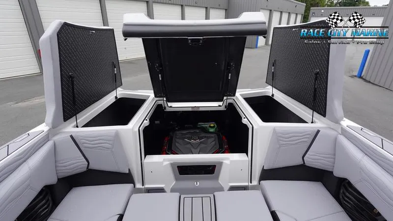 Slide: The Image of 2025 Nautique Super Air Nautique G23 boat interior with open storage compartments. - 17