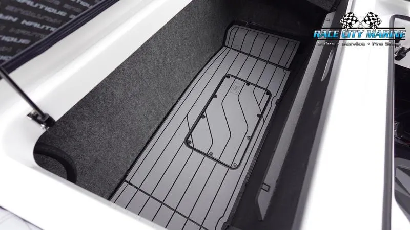 Slide: The Image of 2025 Nautique Super Air Nautique G23 storage compartment with Race City Marine logo. - 19
