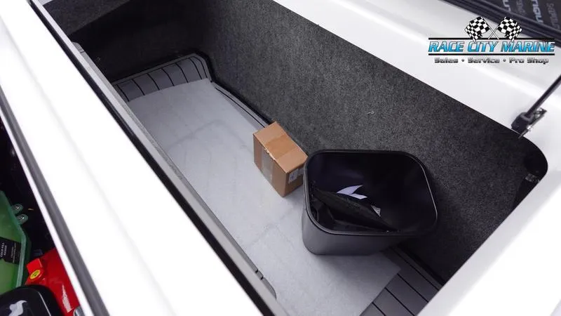 Slide: The Image of Storage compartment of 2025 Nautique Super Air Nautique G23 with box and trash bin. - 20