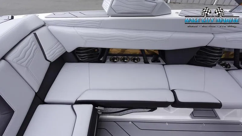 Slide: The Image of 2025 Nautique Super Air Nautique G23 interior with sleek, modern seating and premium audio system. - 23