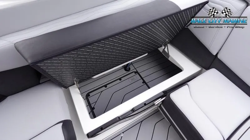 Slide: The Image of 2025 Nautique Super Air Nautique G23 boat storage compartment with open lid. - 24
