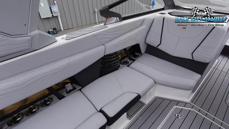 Slide: The Image of 2025 Nautique Super Air Nautique G23 interior with sleek, modern seating and cup holders. - 28