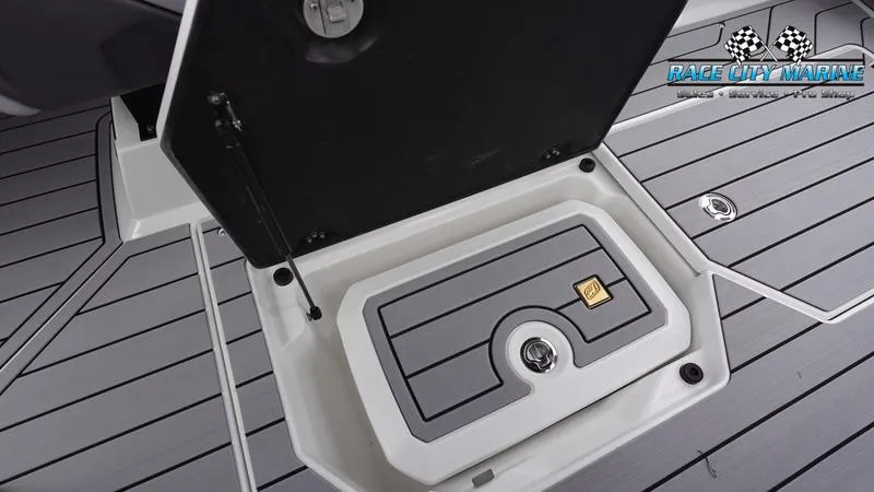 Slide: The Image of 2025 Nautique Super Air Nautique G23 storage compartment on deck. - 31