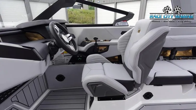 Slide: The Image of Interior of 2025 Nautique Super Air Nautique G23 boat with modern seating and controls. - 32