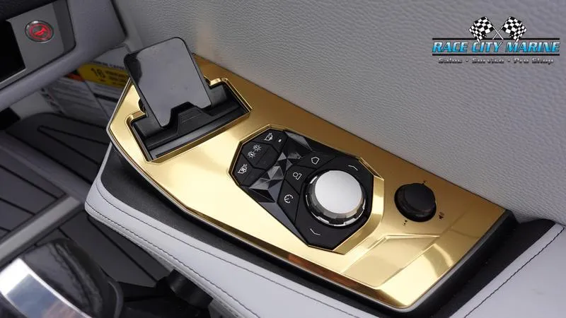 Slide: The Image of 2025 Nautique Super Air Nautique G23 control panel with gold accents. - 35