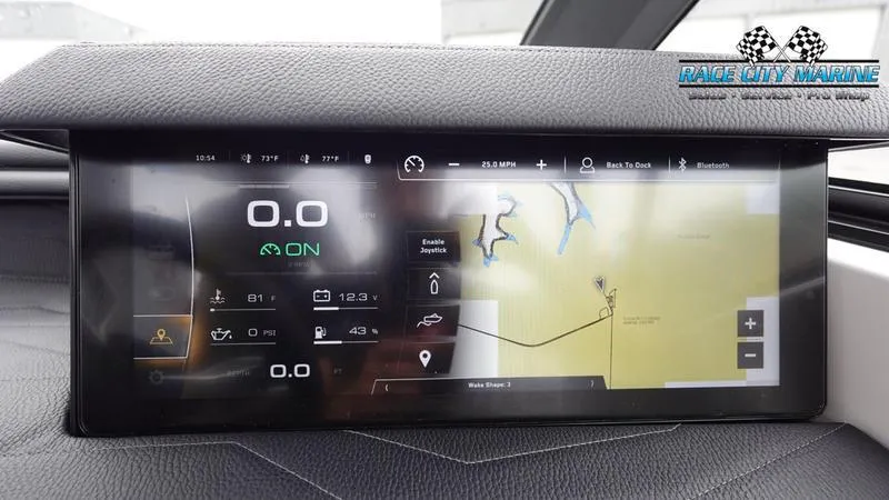 Slide: The Image of 2025 Nautique Super Air Nautique G23 dashboard with digital display and navigation system. - 41