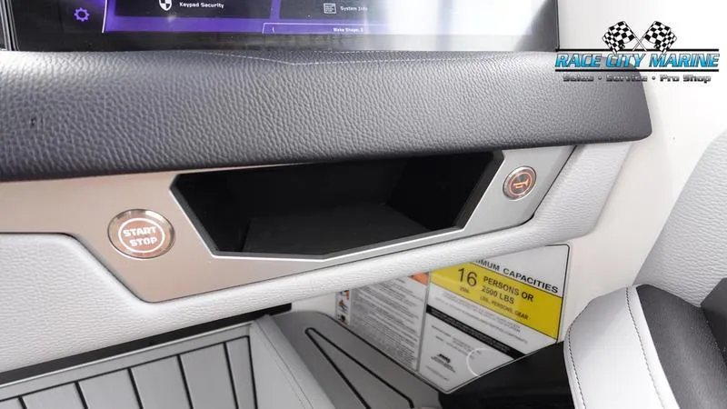 Slide: The Image of Interior of 2025 Nautique Super Air Nautique G23 with start/stop button and storage compartment. - 43