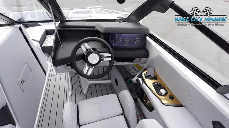 Slide: The Image of 2025 Nautique Super Air Nautique G23 boat interior with modern dashboard and steering wheel. - 44