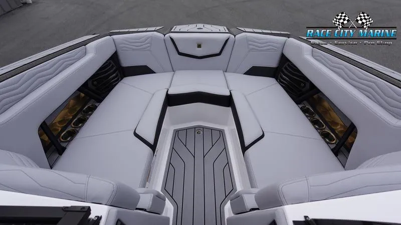 Slide: The Image of 2025 Nautique Super Air Nautique G23 boat interior with luxurious seating and sleek design. - 47