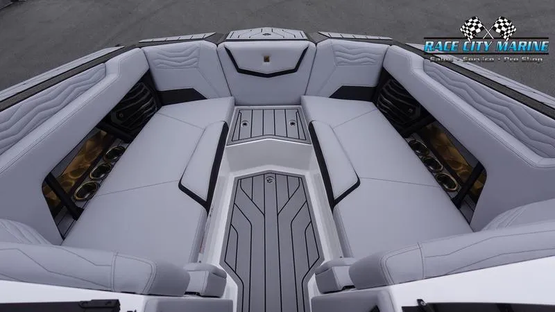 Slide: The Image of 2025 Nautique Super Air Nautique G23 boat interior with luxurious seating and sleek design. - 48