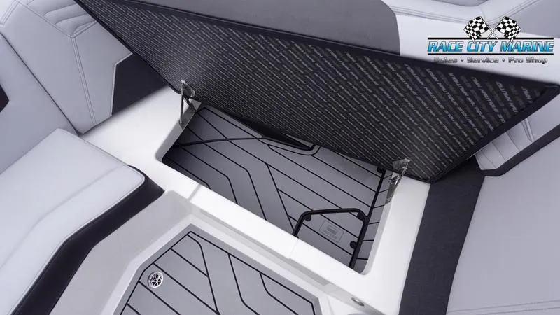 Slide: The Image of 2025 Nautique Super Air Nautique G23 interior storage compartment, Race City Marine logo. - 49