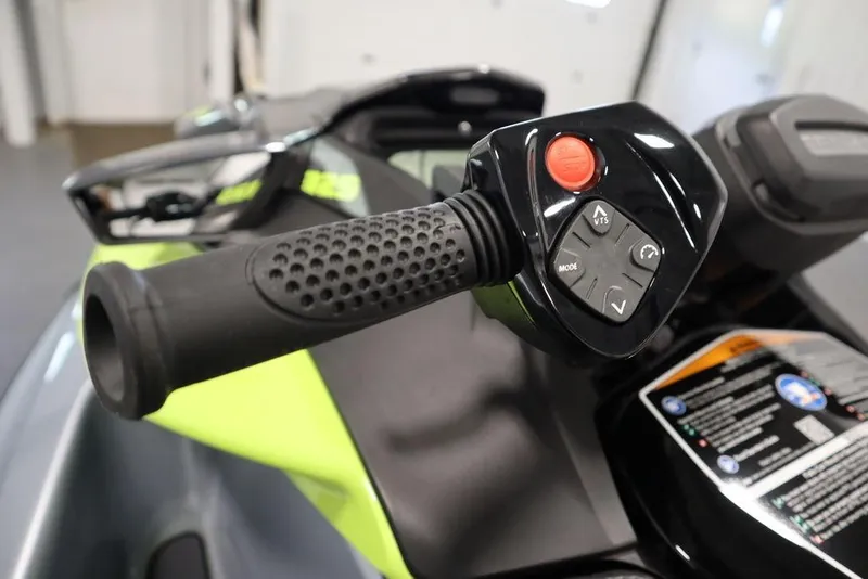 Slide: The Image of Close-up of 2025 Sea-Doo RXP-X 325 handlebar controls, featuring buttons and grip. - 13