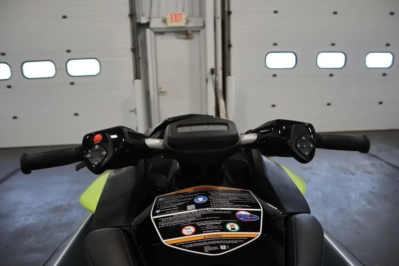 Slide: The Image of 2025 Sea-Doo RXP-X 325 handlebars and dashboard in a garage setting. - 15