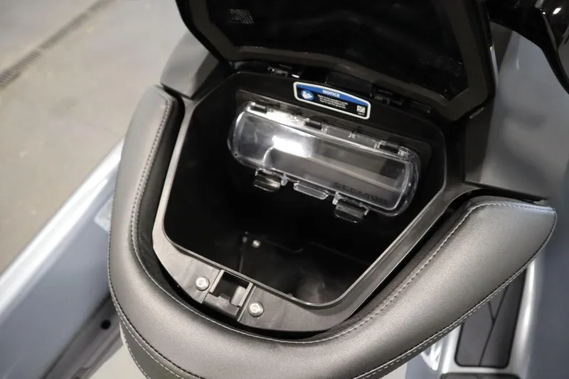 Slide: The Image of 2025 Sea-Doo RXP-X 325 storage compartment with clear cover and sleek design. - 20