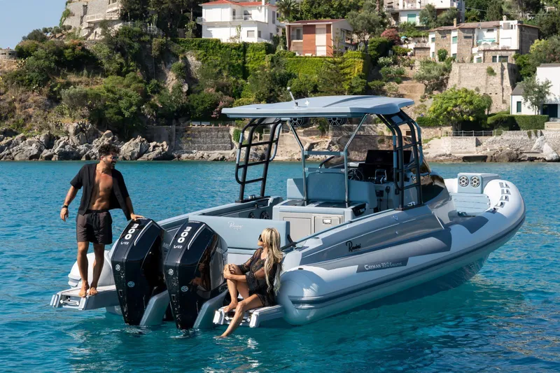 Slide: The Image of 2025 Ranieri Cayman 33 Executive boat on clear blue water near a scenic coastline. - 7