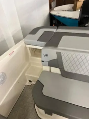 Slide: The Image of 2023 Bayliner VR6 Bowrider Outboard interior with gray seating and VR logo. - 9