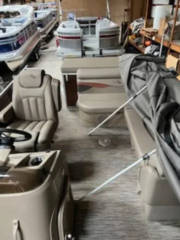 Slide: The Image of 2022 Bennington 168 SF pontoon boat on trailer, covered and parked outdoors. - 1