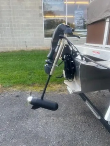 Slide: The Image of 2022 Bennington 168 SF boat motor on trailer, parked on pavement near grass. - 11