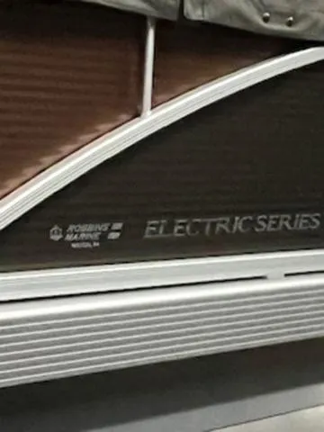 Slide: The Image of 2022 Bennington 168 SF pontoon boat on trailer, covered and parked outdoors. - 5