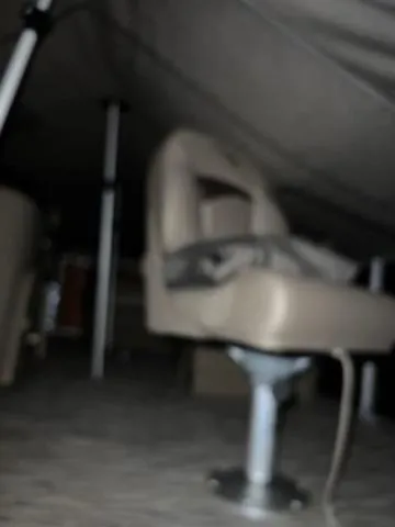 Slide: The Image of Blurry interior of a 2022 Bennington 168 SF boat, featuring a beige seat and metal support. - 8