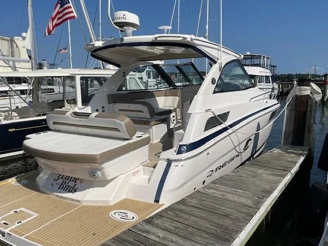 The Image of 2018 Regal 35 Sport Coupe docked at marina, showcasing sleek design and luxury features. - 0