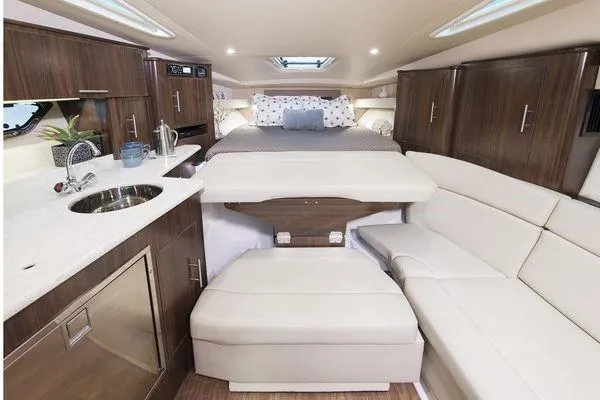 Slide: The Image of Luxurious interior of 2018 Regal 35 Sport Coupe with modern kitchen and cozy sleeping area. - 12