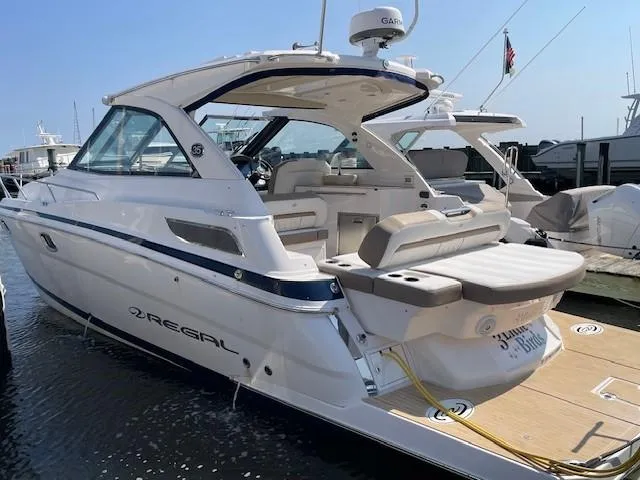 Slide: The Image of 2018 Regal 35 Sport Coupe yacht docked at marina, rear view. - 2