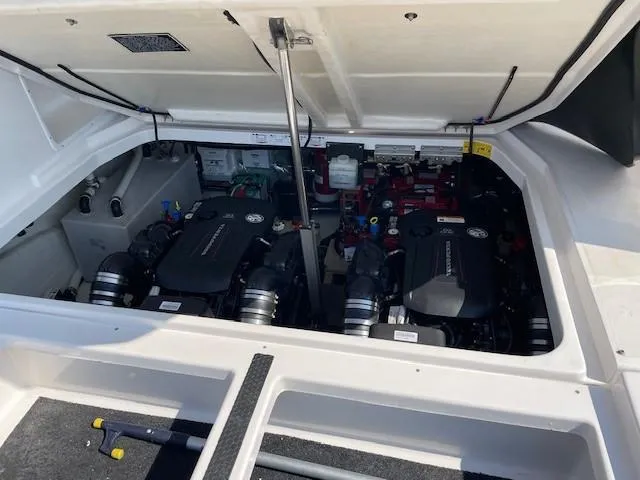 Slide: The Image of Engine compartment of a 2018 Regal 35 Sport Coupe boat, showcasing dual engines. - 29