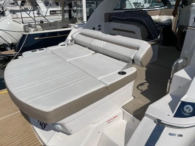 Slide: The Image of 2018 Regal 35 Sport Coupe boat with luxurious white seating and sleek design. - 32